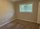 Neutral bedroom featuring carpet, natural light, and closet storage at 1685 Pheasant Dr, Jonesboro, GA 30238