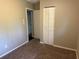 Cozy bedroom featuring neutral walls, carpet and closet with bi-fold doors at 1685 Pheasant Dr, Jonesboro, GA 30238