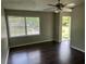 Bright living room featuring hardwood floors, ceiling fan, and view to outdoor space at 1685 Pheasant Dr, Jonesboro, GA 30238