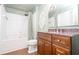 Well-lit bathroom featuring a tub with shower, vanity with modern fixtures, and marble countertop at 3040 Peachtree Nw Rd # 815, Atlanta, GA 30305