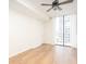 Bright bedroom with hardwood floors, a ceiling fan, and large windows offering city views at 3040 Peachtree Nw Rd # 815, Atlanta, GA 30305