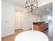 Open kitchen features wood cabinets, stainless steel appliances, black countertops, and modern light fixture at 3040 Peachtree Nw Rd # 815, Atlanta, GA 30305