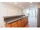 Well-lit kitchen featuring granite countertops, wooden cabinets and modern appliances, with large windows at 3040 Peachtree Nw Rd # 815, Atlanta, GA 30305