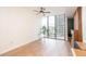 Bright living room featuring expansive windows with city views and hardwood floors at 3040 Peachtree Nw Rd # 815, Atlanta, GA 30305