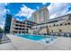 Relaxing outdoor pool with lounge chairs on a sundeck overlooking the city skyline at 3040 Peachtree Nw Rd # 815, Atlanta, GA 30305