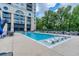 Outdoor pool with lounge chairs surrounded by lush landscaping and city views at 3040 Peachtree Nw Rd # 815, Atlanta, GA 30305