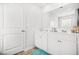 Bright bathroom features double sinks, white cabinets, a large mirror, and tiled floors at 3135 Ellenton Dr, Lithia Springs, GA 30122