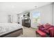 Bedroom with bed, dresser, and chair lit by natural light from two windows at 3135 Ellenton Dr, Lithia Springs, GA 30122