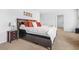 Bedroom features a bed with decorative pillows, a bedside table, and neutral carpeting at 3135 Ellenton Dr, Lithia Springs, GA 30122