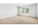 Empty bedroom featuring carpet floors and a bright window view at 3135 Ellenton Dr, Lithia Springs, GA 30122