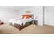 Spacious bedroom featuring a bed with orange pillows, neutral walls, and carpeted floors at 3135 Ellenton Dr, Lithia Springs, GA 30122