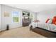 Cozy bedroom with a dresser, TV, windows, and a comfortable bed with orange pillows at 3135 Ellenton Dr, Lithia Springs, GA 30122