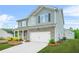Two-story home featuring a combination of brick and siding, along with a neat lawn and a convenient two-car garage at 3135 Ellenton Dr, Lithia Springs, GA 30122
