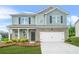Charming two-story home featuring a mix of brick and siding, complemented by a well-manicured lawn and a two-car garage at 3135 Ellenton Dr, Lithia Springs, GA 30122