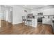 Bright kitchen features stainless appliances, white cabinetry, and wood flooring at 3135 Ellenton Dr, Lithia Springs, GA 30122