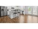 Bright kitchen boasts stainless appliances, white cabinetry, and wood flooring at 3135 Ellenton Dr, Lithia Springs, GA 30122