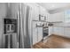 Bright kitchen features stainless appliances, white cabinetry, and wood flooring at 3135 Ellenton Dr, Lithia Springs, GA 30122