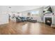 Open-concept living room features wood floors, a fireplace, and a view into the kitchen at 3135 Ellenton Dr, Lithia Springs, GA 30122