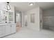 Bright bathroom featuring marble floors, double vanity, and glass enclosed shower with bench at 340 Colewood Way, Atlanta, GA 30328