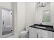 Modern bathroom with a glass enclosed shower, marble tiling and black hardware and fixtures at 340 Colewood Way, Atlanta, GA 30328