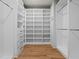 Walk-in closet with custom white shelving and drawers, providing ample storage space at 340 Colewood Way, Atlanta, GA 30328