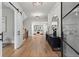 Bright foyer with hardwood floors, a modern light fixture, an accent mirror, and sliding barn doors at 340 Colewood Way, Atlanta, GA 30328