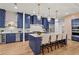 Stylish kitchen with navy blue cabinetry, marble countertops, stainless steel appliances, and an island with seating at 340 Colewood Way, Atlanta, GA 30328