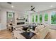 Bright living room with a modern fireplace, large windows, and stylish decor with views of the tree canopy at 340 Colewood Way, Atlanta, GA 30328