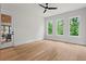 Sunlit open concept living area with hardwood floors and views of lush greenery at 340 Colewood Way, Atlanta, GA 30328