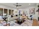 Spacious living room with fireplace, modern furniture, and open access to the kitchen and dining area at 340 Colewood Way, Atlanta, GA 30328