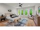 Serene main bedroom with large windows, modern furnishings, and a calming color palette with a beautiful tree canopy view at 340 Colewood Way, Atlanta, GA 30328