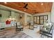 Stylish outdoor kitchen and lounge area with stainless steel appliances, wood ceiling, and comfortable seating at 340 Colewood Way, Atlanta, GA 30328