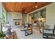 Inviting outdoor living space featuring a fireplace, full kitchen, and comfortable seating with a wood ceiling at 340 Colewood Way, Atlanta, GA 30328