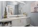 Elegant powder room with marble countertop, decorative mirror, stylish light fixture, and modern vanity at 340 Colewood Way, Atlanta, GA 30328