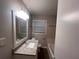 Well-lit bathroom showcasing a granite countertop, modern vanity, and a combination shower at 3948 Valley Brook Rd, Snellville, GA 30039