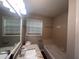 Well-lit bathroom with a granite-topped vanity, large mirror, and combination tub and shower at 3948 Valley Brook Rd, Snellville, GA 30039