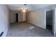 Carpeted bedroom with ceiling fan and open closet at 3948 Valley Brook Rd, Snellville, GA 30039