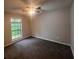 Bedroom featuring a large window bringing natural light and plush carpeting at 3948 Valley Brook Rd, Snellville, GA 30039