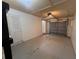 An empty garage features a gray garage door, an interior door, and an electric garage door opener at 3948 Valley Brook Rd, Snellville, GA 30039