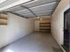This garage includes a new gray garage door, shelving and an interior door leading to the home at 3948 Valley Brook Rd, Snellville, GA 30039