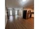 Open-concept living room and kitchen featuring wood floors, fireplace, and stainless steel appliances at 3948 Valley Brook Rd, Snellville, GA 30039