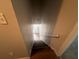 A stairwell featuring wooden stairs and a painted handrail leading up towards a white front door at 3948 Valley Brook Rd, Snellville, GA 30039