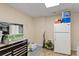 Basement storage area featuring a refrigerator, shelving, and concrete flooring at 401 Farm Brook Ln, Dallas, GA 30157