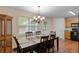 Dining room with a table, chairs, and modern lighting fixture at 401 Farm Brook Ln, Dallas, GA 30157