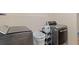 Modern laundry room features a front load washer and dryer in grey at 401 Farm Brook Ln, Dallas, GA 30157