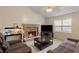 Inviting living room with a stone fireplace, bright windows, and comfortable furniture at 401 Farm Brook Ln, Dallas, GA 30157
