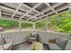 Covered porch featuring a grey sofa and green tree views at 401 Farm Brook Ln, Dallas, GA 30157