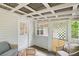 Covered porch featuring a grey sofa with a white screen door at 401 Farm Brook Ln, Dallas, GA 30157