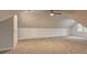 Large attic with plush carpeting, recessed lighting, and an efficient ceiling fan at 5621 Wildwood Trl, Lithonia, GA 30038
