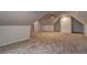 Spacious attic with plush carpeting, recessed lighting, and an efficient ceiling fan at 5621 Wildwood Trl, Lithonia, GA 30038